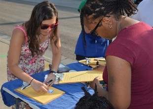 People signing in to the event Story Time in the Heights (photo).
